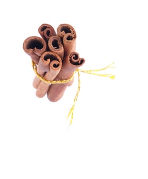 bunch of cinnamon sticks tied by yellow rope (isolated on white background)