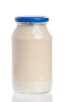 glass jar of mayonnaise blue cap isolated on white background