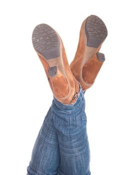 woman with legs up in jeans wearing leather fashion boots (isolated on white background)