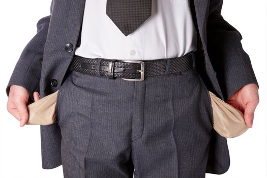 Businessman wearing a tie and showing empty pockets isolated on a white background