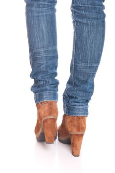legs in jeans wearing leather fashion boots isolated on white background (back posing)