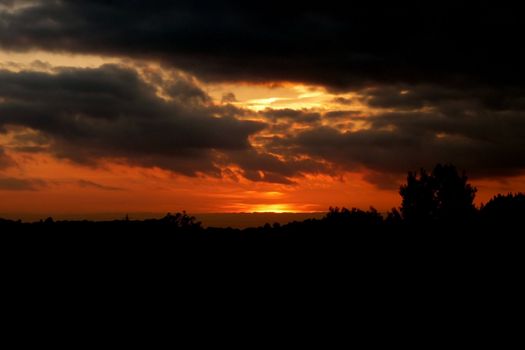 The setting sun over a landscape in Swindon