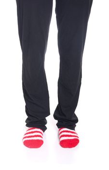 woman legs in pyjamas with red socks on white background