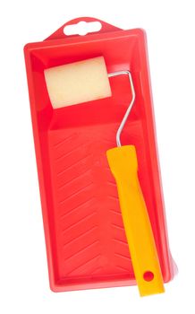 small paint roll utensil on a red tray isolated on white background