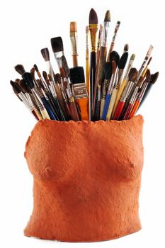 Collection of brushes in a ceramic vase as a female torso