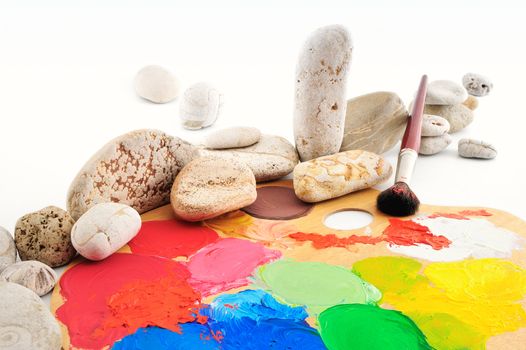 Sea gravel next to the palette and paintbrush
