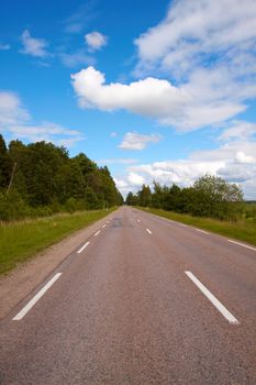 Road, freeway seemingly disappearing into the horizon. Sunny summer day. Transportation, travel concept