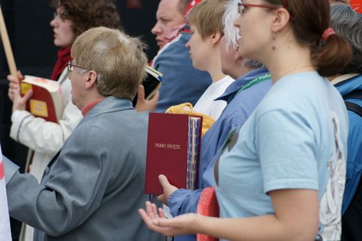 Warszaw, Poland - June 06: Woman who have a Sacred Scripture in Pilsudzkiego square on the Cross devotion Pope John  Paul II in the 20th anniversary of the Polish pope. About the pilgrimage: "Let your spirit come down and renew the  face of the earth"