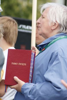 Warszaw, Poland - June 06: Woman who have a Sacred Scripture in Pilsudzkiego square on the Cross devotion Pope John  Paul II in the 20th anniversary of the Polish pope. About the pilgrimage: "Let your spirit come down and renew the  face of the earth"