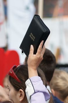 Warszaw, Poland - June 06: Woman who have a Sacred Scripture in Pilsudzkiego square on the Cross devotion Pope John  Paul II in the 20th anniversary of the Polish pope. About the pilgrimage: "Let your spirit come down and renew the  face of the earth"