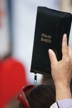 Warszaw, Poland - June 06: Woman who have a Sacred Scripture in Pilsudzkiego square on the Cross devotion Pope John  Paul II in the 20th anniversary of the Polish pope. About the pilgrimage: "Let your spirit come down and renew the  face of the earth"