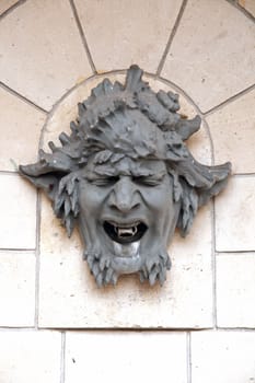 mascaron, fountain hung on the wall of a fontaine, this devil's face was supposed to protect from the evil eye