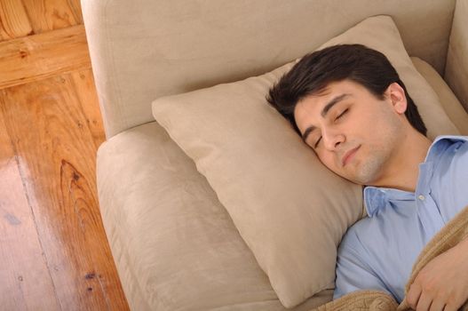 attractive young man sleeping on the couch