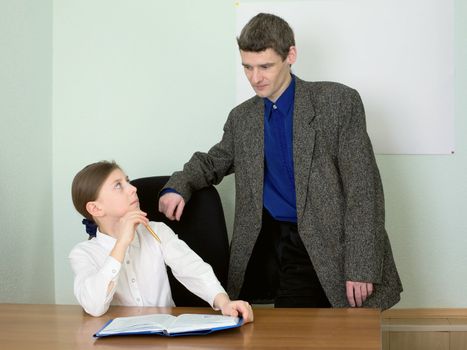 Teacher in a suit and schoolgirl with book