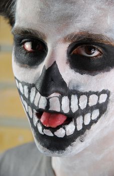 close-up portrait of a creepy skeleton guy perfect for Carnival (brick wall background)