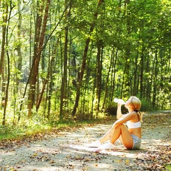 Pretty young girl runner in the forest.