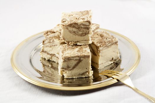 Delicious Halva served in silver-golden dish on white table