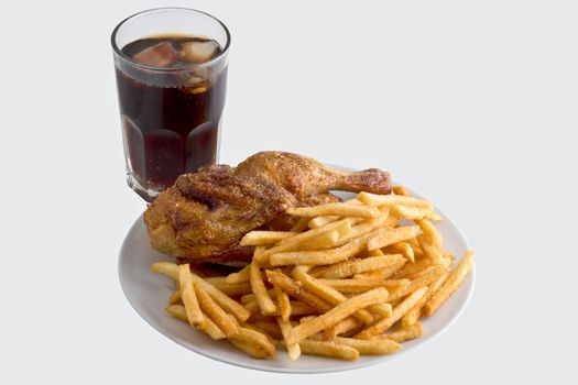 Plate fried chicken with french fries next to a cold cola. Isolated