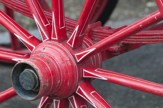 Anicent red wheel in a horse driven wagon
