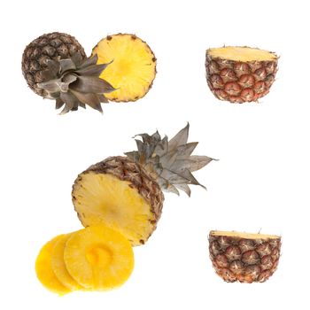 Whole and half pinapple detail isolated on white background.