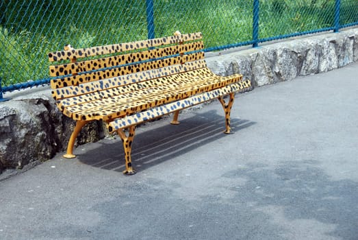 yellow spotted bench in animal design in park outdoor