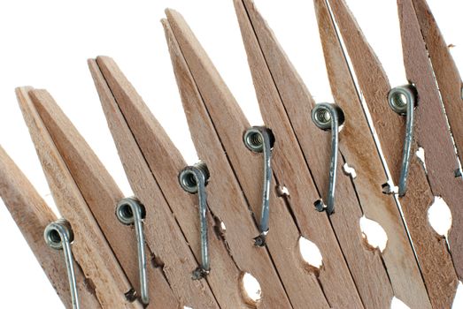 Wooden clothes pegs isolated on white background.
