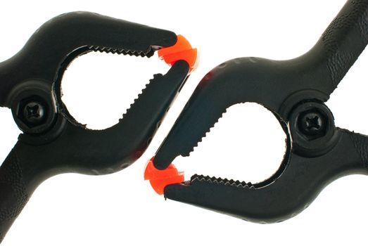 Red and black plastic clamps isolated on white background.