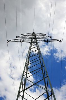This image shows a power pole with sky and clouds