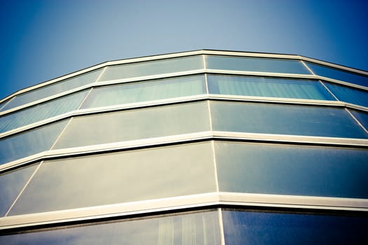 skyscraper windows are reflecting deep blue sky