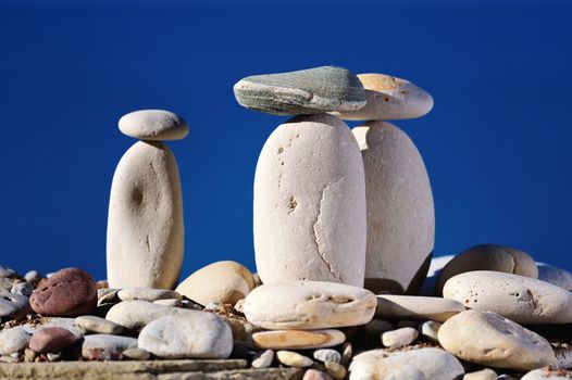 Long white pebbles on a background of blue sky