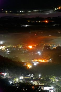 Colorful rural night scenery with light in town.