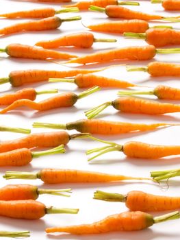 close up of baby carrots on white