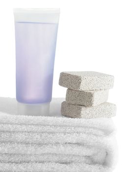 A spa scene on top of fluffy white towels against a white background.