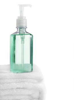 A spa scene on top of fluffy white towels against a white background.