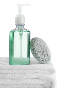 A spa scene on top of fluffy white towels against a white background.