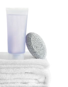 A spa scene on top of fluffy white towels against a white background.