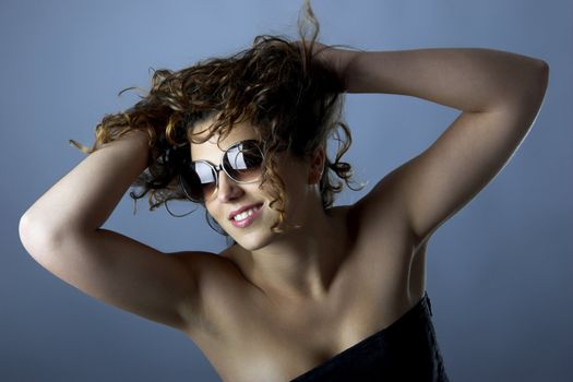 Studio Portrait of a beautiful young woman with glasses