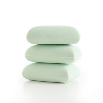 Stack of green soap bars against a white background.