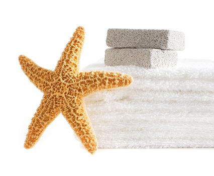Starfish, towels, and pumice stones against a white background.