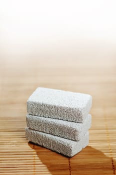 Stack of pumice stones on top of a bamboo mat.