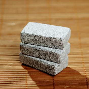 Stack of pumice stones on top of a bamboo mat.