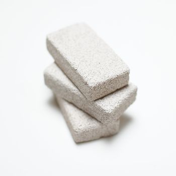 Stack of pumice stones on a white background.