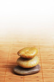 Stack of rocks on top of a bamboo mat.