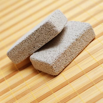 Pumice stones on display on a bamboo mat.
