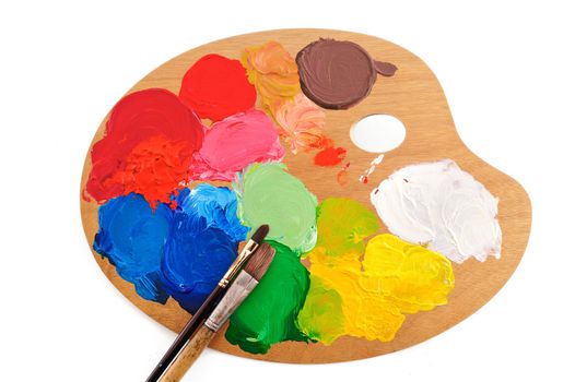 Two paintbrush on the palette with bright acrylic paints