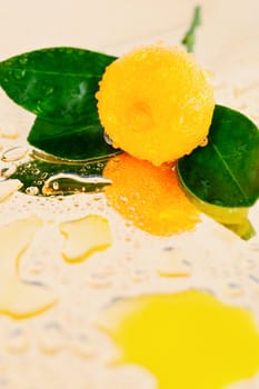 Close-up mandarin with leaves covered with drops of water