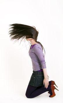 Portrait of a young brunette with her long hair blowing out