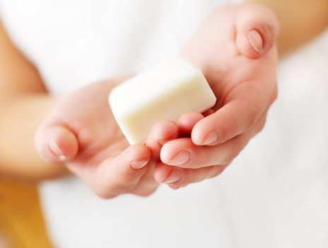 Closeup of womans hands holding spa treatment.