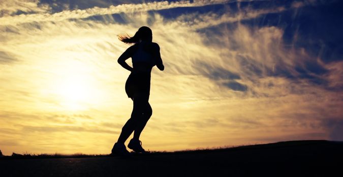 Beautiful young woman runner having a workout session.