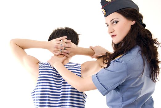 Young woman in police uniform arresting a criminal